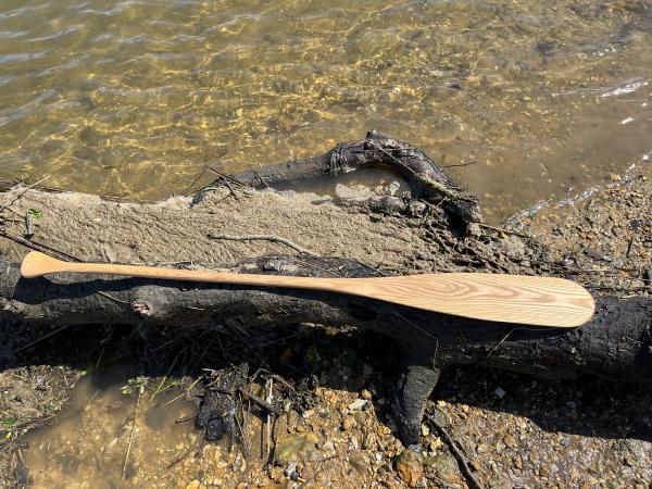 The completed paddle, on a log